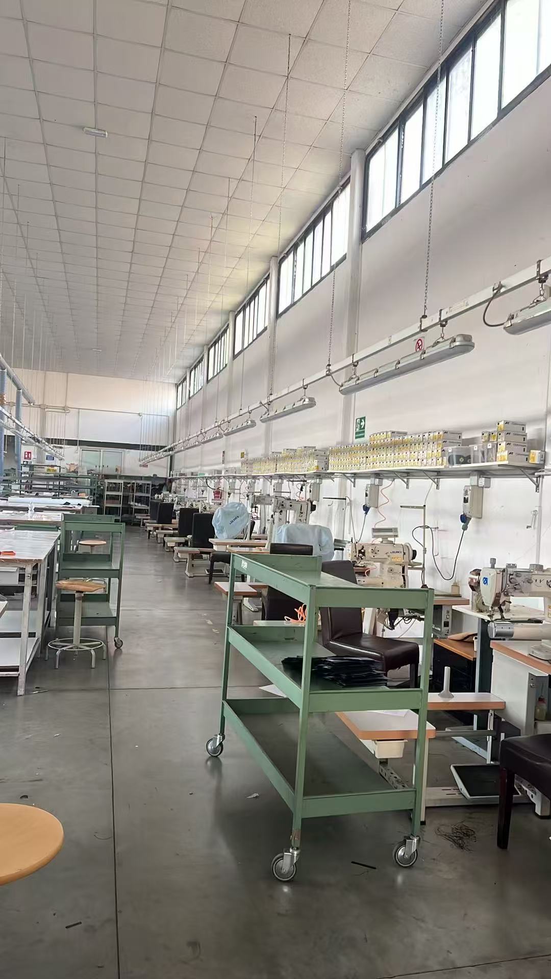 Sewing stations and worktables used in leather bag production